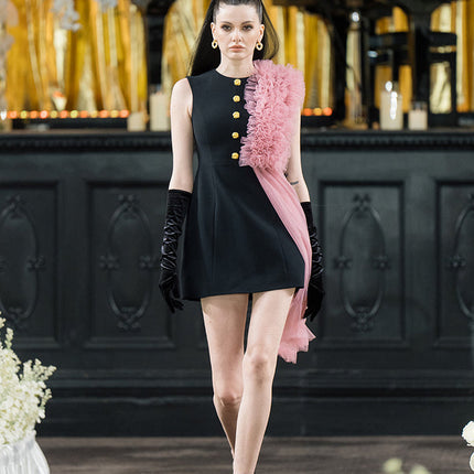 Sophia black dress with a classic A-line silhouette, gold button details, and dramatic pink tulle embellishment, crafted from polyester and nylon.