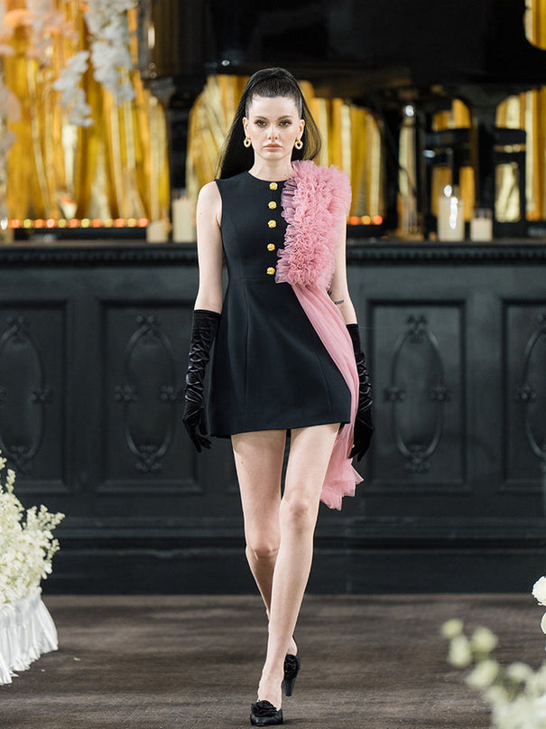 Sophia black dress with a classic A-line silhouette, gold button details, and dramatic pink tulle embellishment, crafted from polyester and nylon.