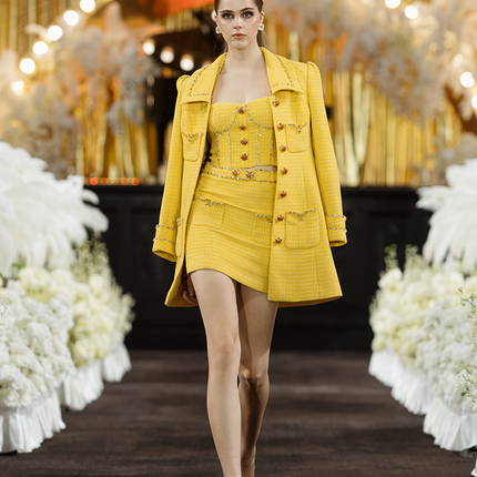 Sophia embellished tweed mini skirt in vibrant yellow with a high-waisted fit, crystal embellishments, gemstone belt, and front pocket details, crafted from 100% polyester.