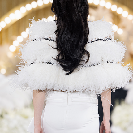 Sophia feather-embellished cape with tiered ostrich feathers, black trim accents, and a relaxed fit, crafted from lightweight polyester.