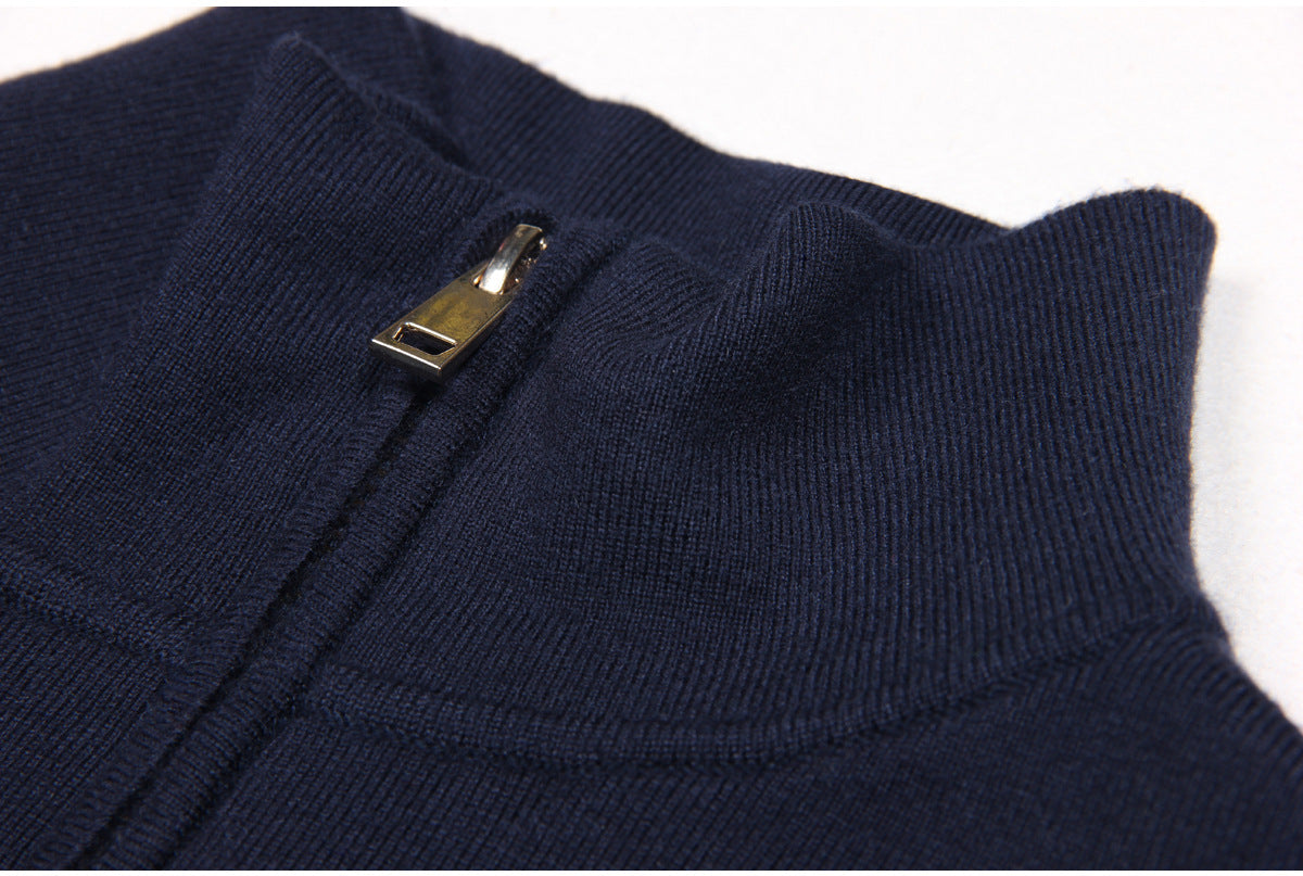 Navy bomber jacket featuring denim patch pockets, a full front zipper, smocked waistband, cuffs, and decorative gold-tone buttons