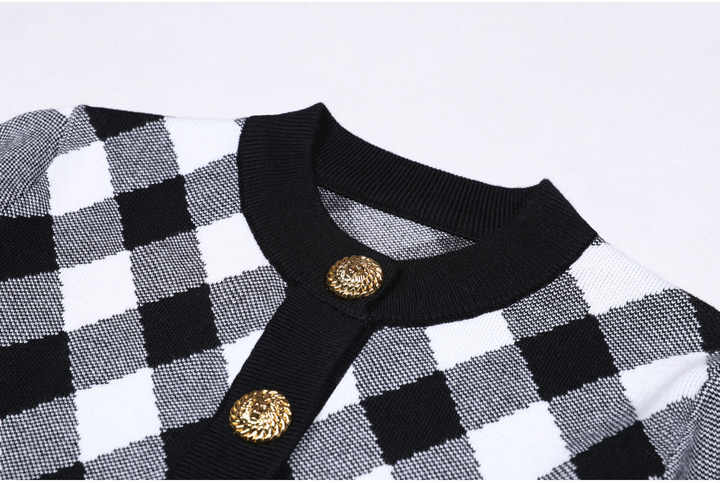 Elegant black and white argyle-patterned knit cardigan with gold button details
