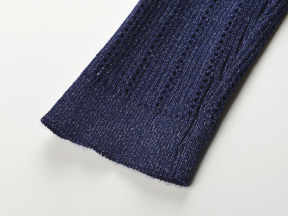Navy blue knitted cardigan with shimmering texture, decorative gold buttons, and fitted waist