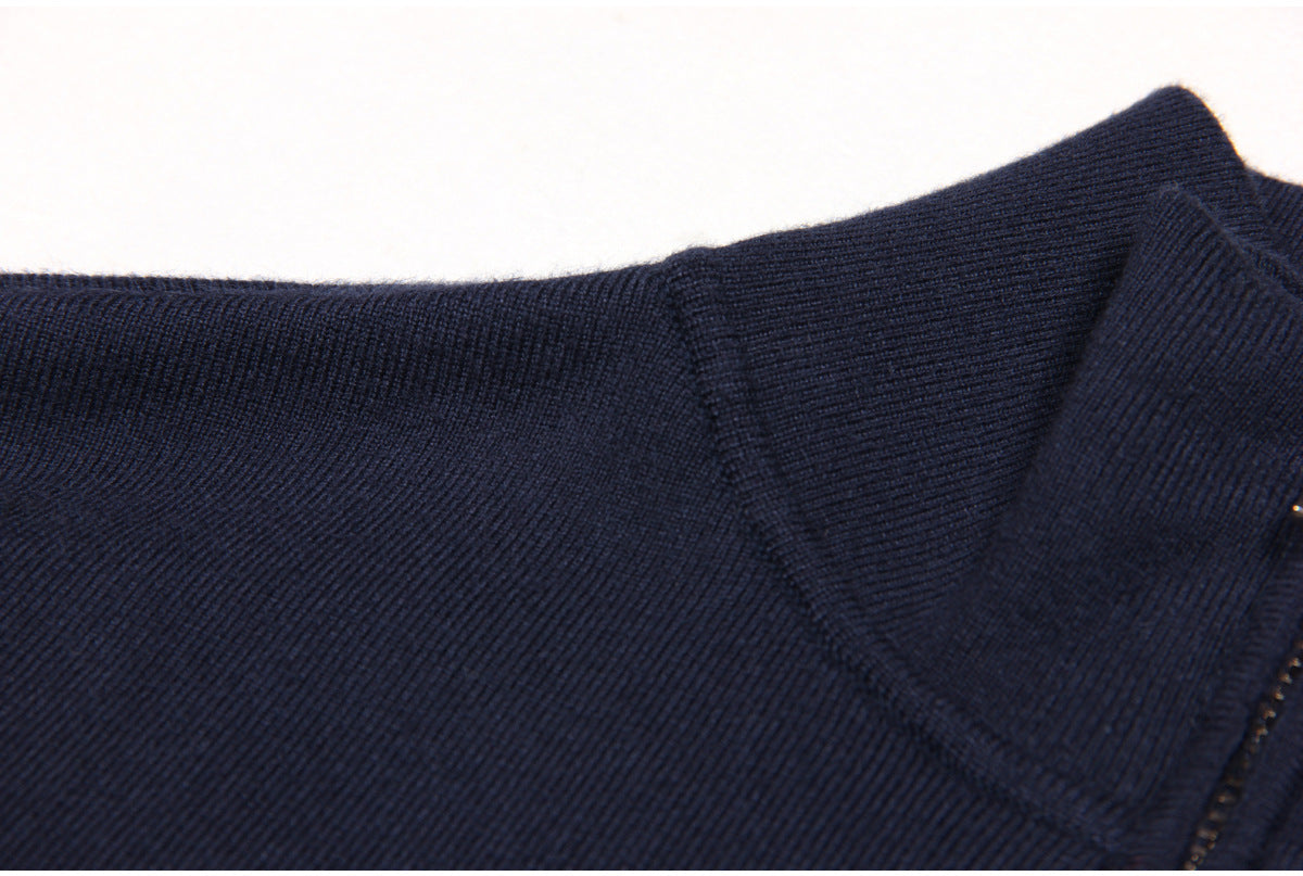 Navy bomber jacket featuring denim patch pockets, a full front zipper, smocked waistband, cuffs, and decorative gold-tone buttons