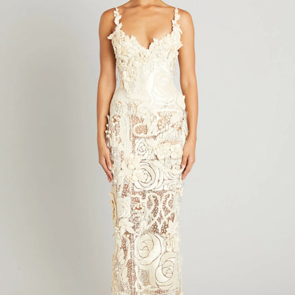Woman wearing a white lace dress on a plain background