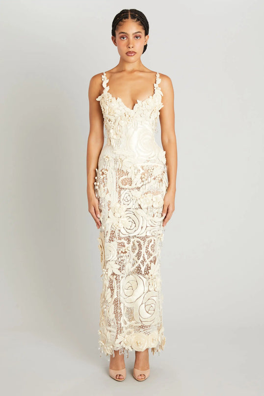Woman wearing a white lace dress on a plain background