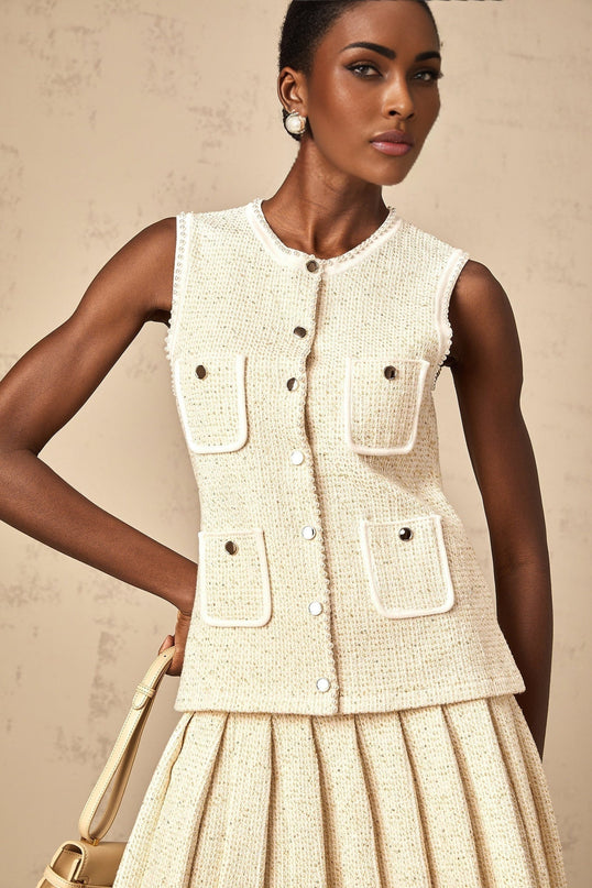 A beige knit vest top and matching skirt set adorned with sequins called Helene The top is sleeveless and the skirt appears to be knee length Both pieces feature a textured knit fabric with shimmering sequin embellishments throughout
