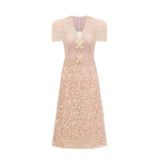 A beige midi dress with crochet detailing and faux flower embellishments in neutral tones
