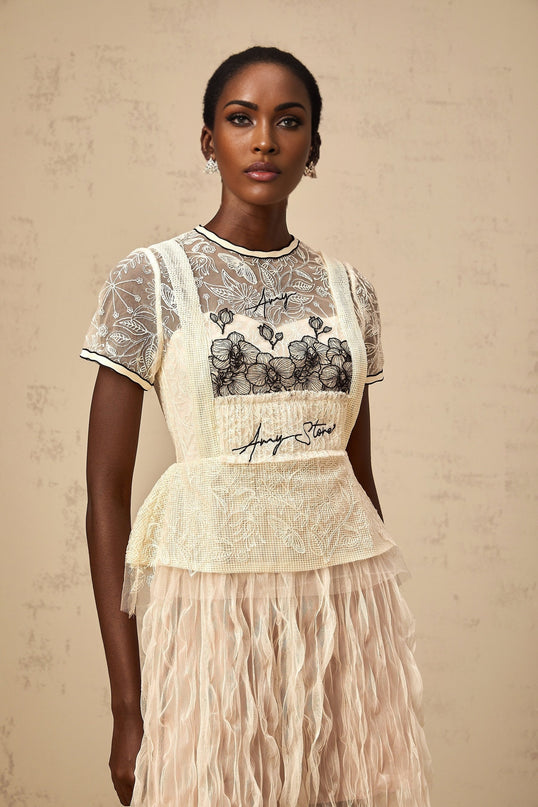 A beige midi dress with embroidered tulle fabric named Sandrine featuring delicate floral patterns and a feminine silhouette