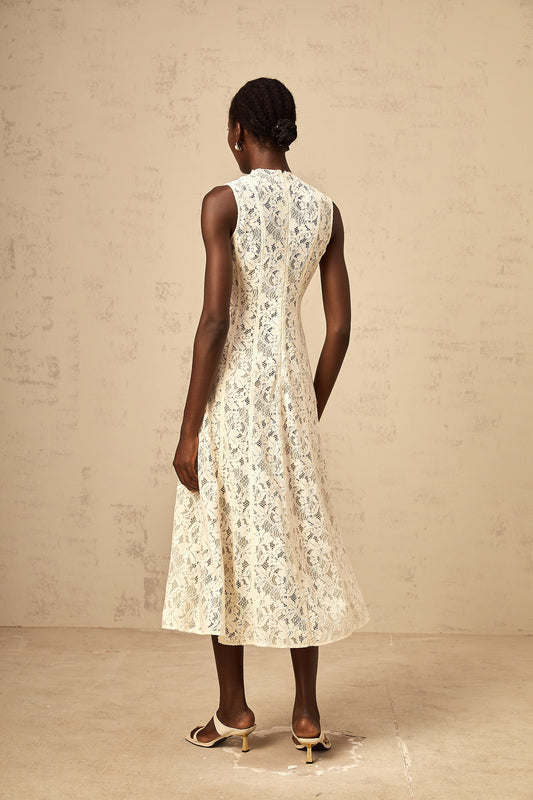 A beige midi dress with floral lace pattern and flared skirt design