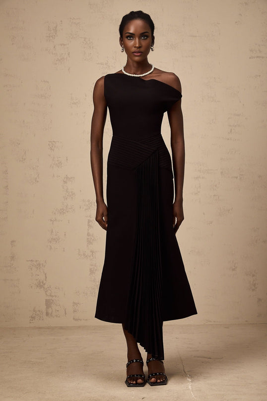 A black asymmetric midi dress with draped details named Laurine shown on a model or mannequin