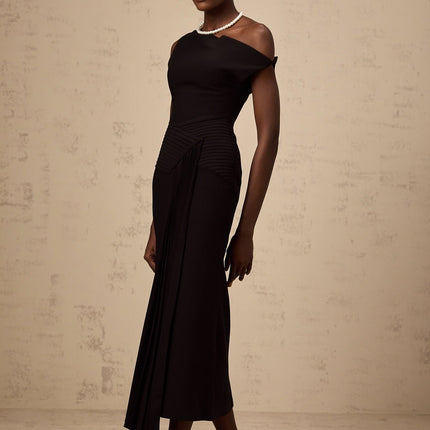 A black asymmetric midi dress with draped fabric detail featuring a sleek design and uneven hemline