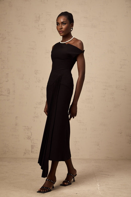 A black asymmetric midi dress with draped fabric detail featuring a sleek design and uneven hemline