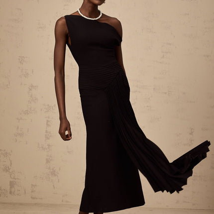 A black asymmetric midi dress with draped fabric details named Laurine featuring an uneven hemline and flowing silhouette