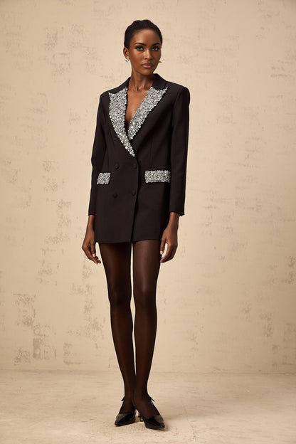 A black blazer adorned with crystal embellishments featuring a tailored silhouette and shimmering accents
