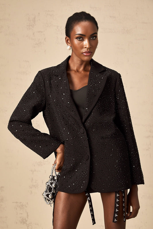 A black blazer adorned with studs featuring a tailored silhouette and embellished details