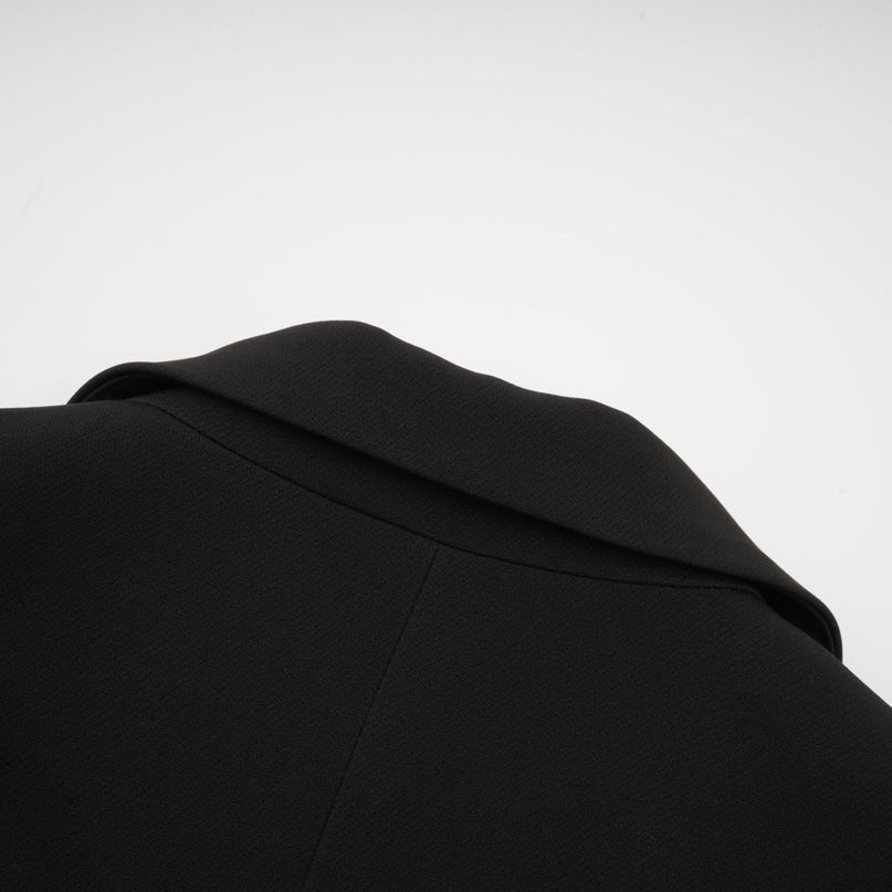 A black blazer with a bowknot detail and cutout design featuring a feminine silhouette named Justine