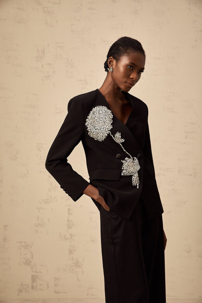 A black blazer with an allover floral pattern featuring embellished flower motifs