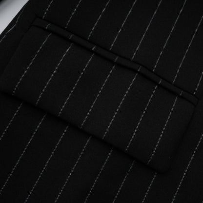 A black blazer with white stripes featuring an open back design worn by a model