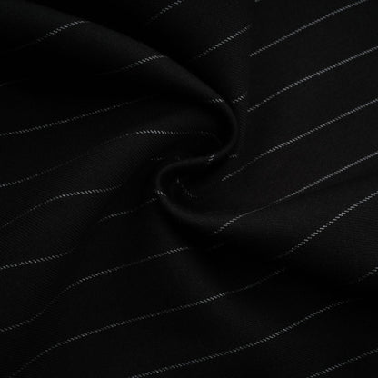 A black blazer with white stripes featuring an open back design worn by a model