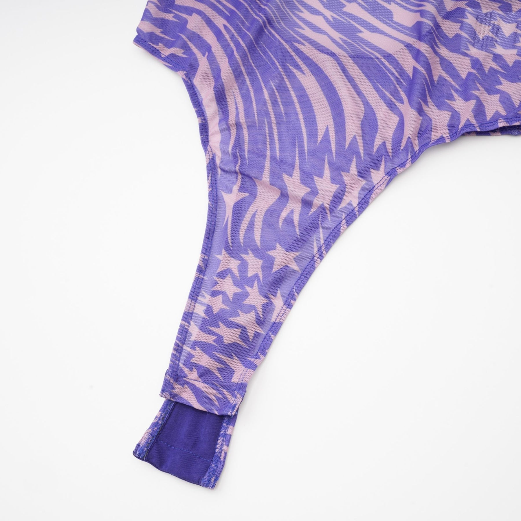 black bodysuit with sheer mesh fabric adorned with white star prints covering the entire garment