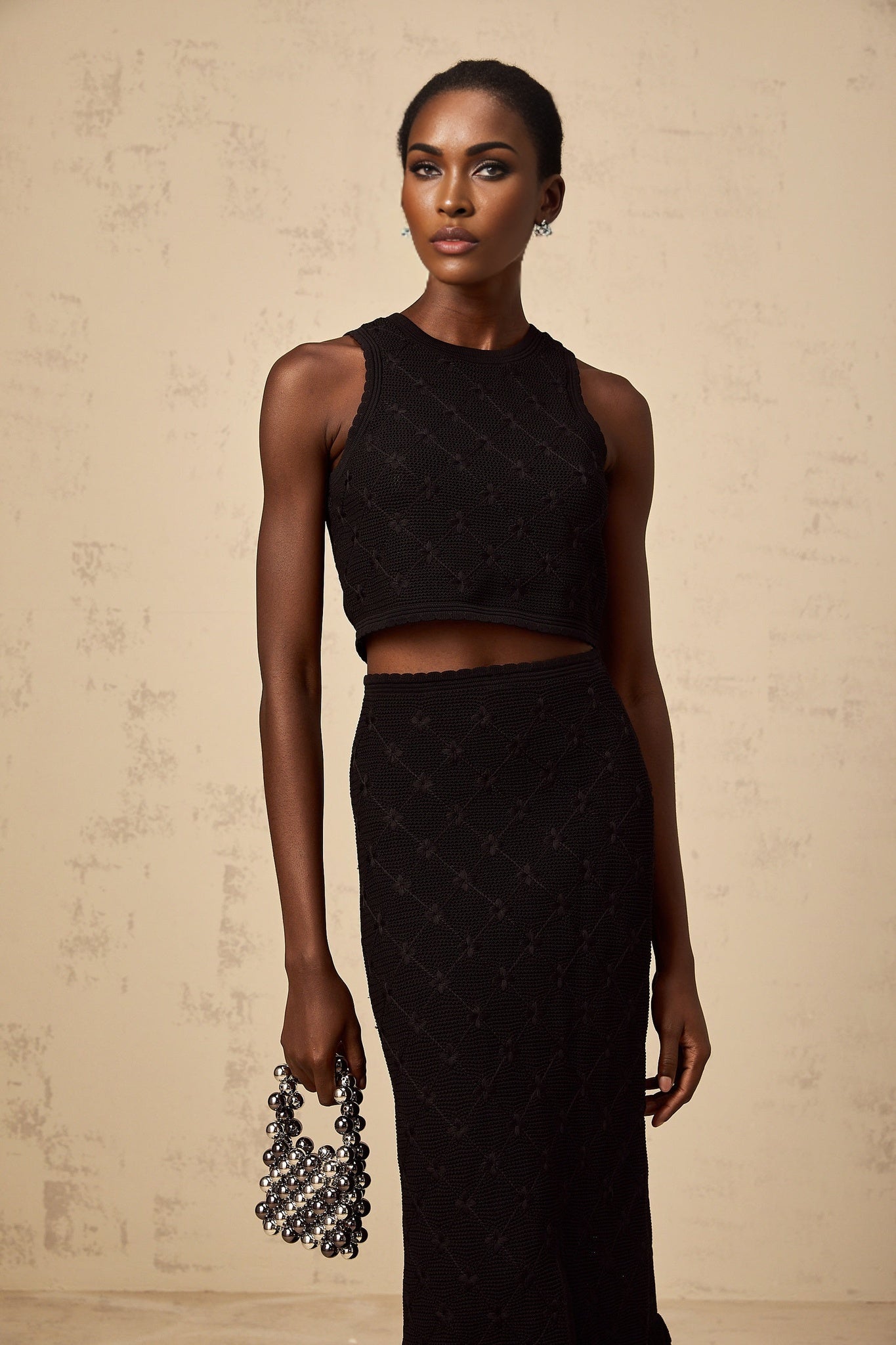 A black crochet knit matching set featuring a top and skirt Joelle style