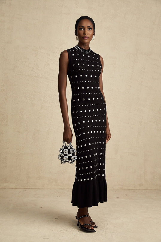 A black crochet knit maxi dress with studded details by Chloé featuring long sleeves and a flowing silhouette