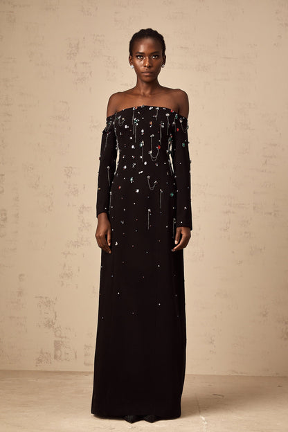 A black crystal embellished offshoulder maxi dress with a flowing silhouette named Gabrielle