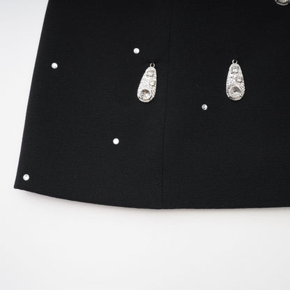 Black dress with front bowknot detailing adorned with embellishments rear zip fastening and made of 100% Polyester