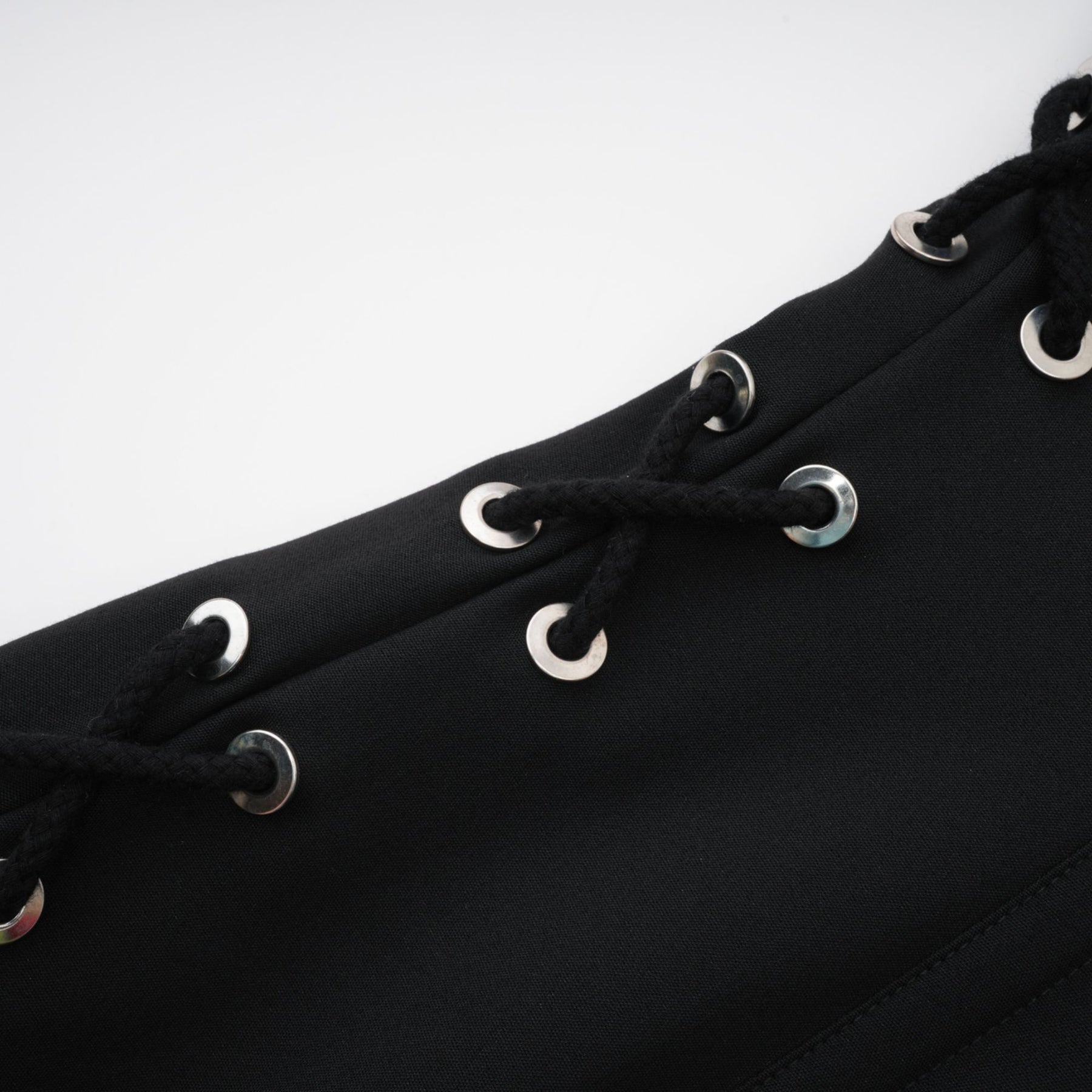 Black sleeveless dress with Vneck boned bodice and chest flap pockets Made of 98% Organic Cotton and 2% Elastane