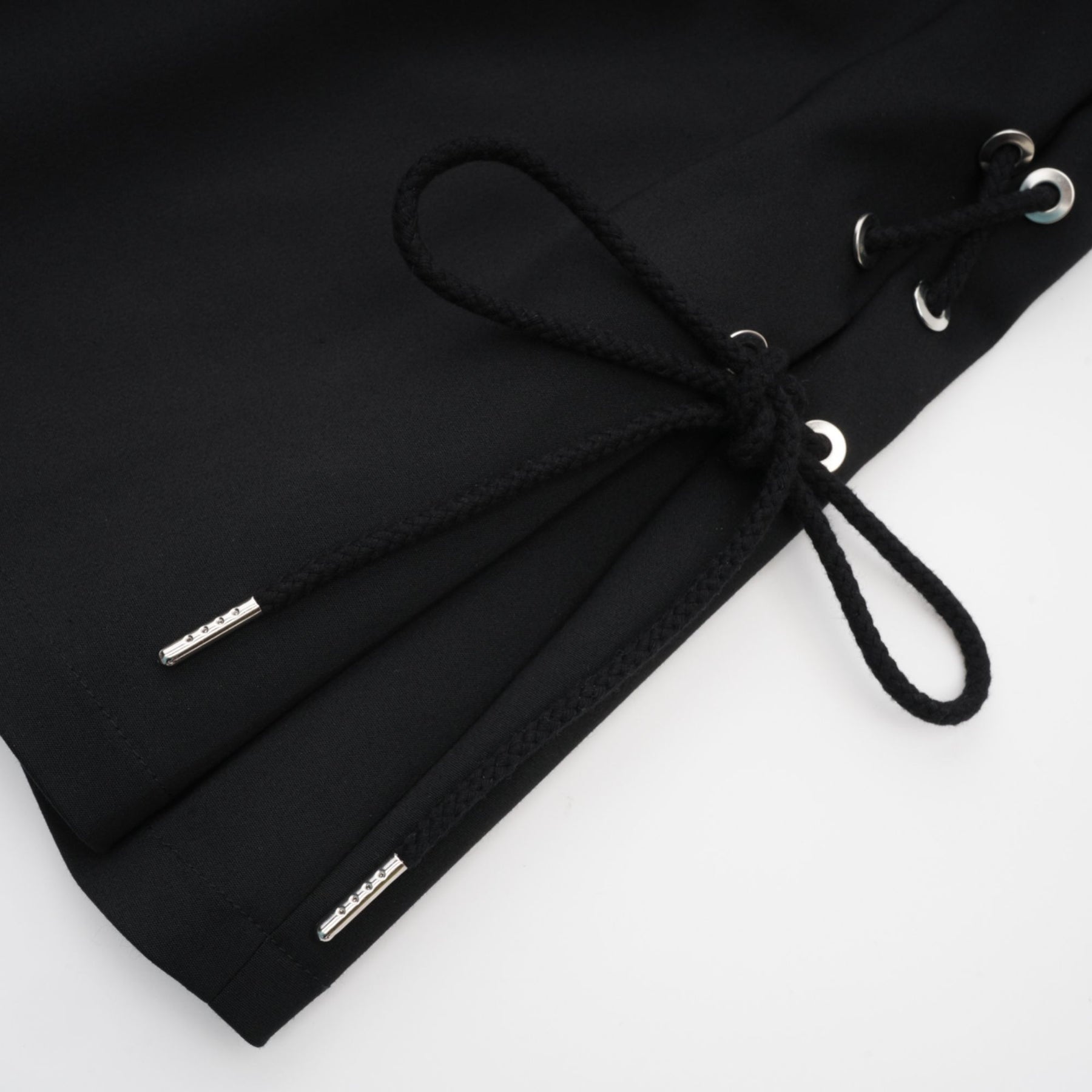 Black sleeveless dress with Vneck boned bodice adjustable straps rear zip chest pockets and thighlength coverage in organic cotton and elastane blend