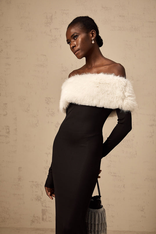 A black faux fur midi dress with an offshoulder neckline featuring a sleek silhouette and plush texture
