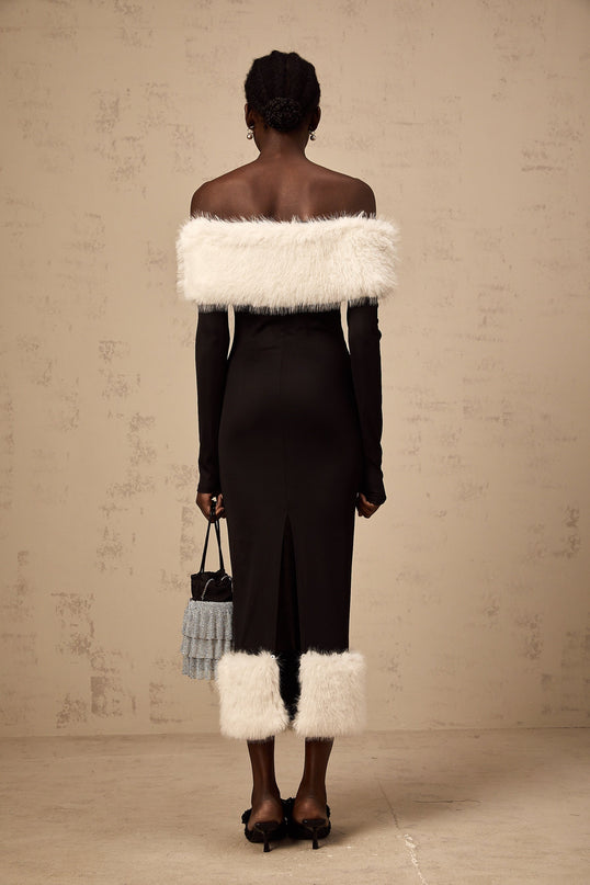 A black faux fur off shoulder midi dress on a mannequin or model showing the garments fitted silhouette and plush texture
