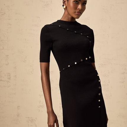 A black fineknit mini dress with decorative buttons named Wanda on a plain background