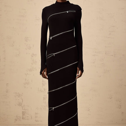 A black fitted maxi dress with zippered details and a long silhouette named Costanza