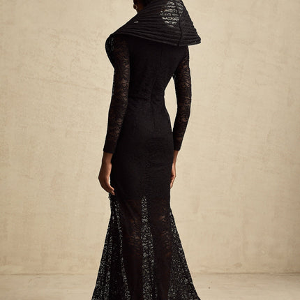A black floorlength fishtail dress with a structured bodice and split detail worn by a model