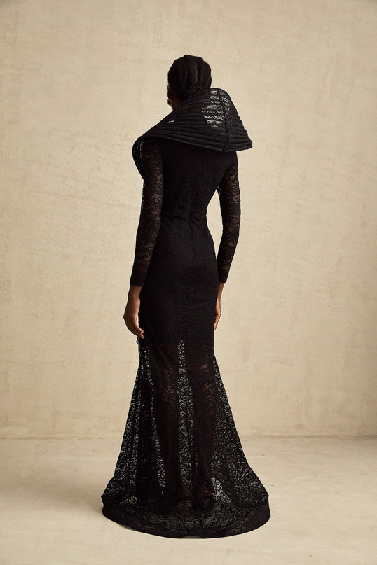 A black floorlength fishtail dress with a structured bodice and split detail worn by a model