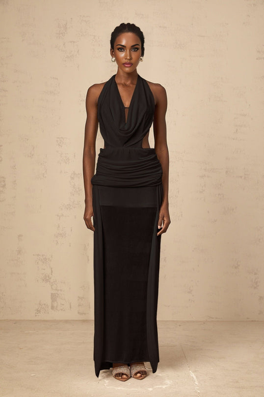 A black floorlength maxi dress with a halter neckline and open back design worn by a model