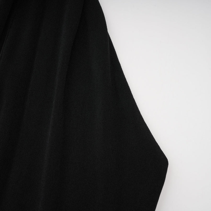 A black floorlength maxi dress with a hood featuring floral appliqué detailing called Axelle