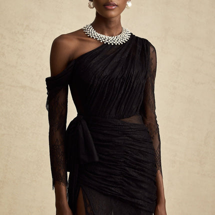 A black floorlength maxi dress with a single shoulder strap and a cut out detail on one side