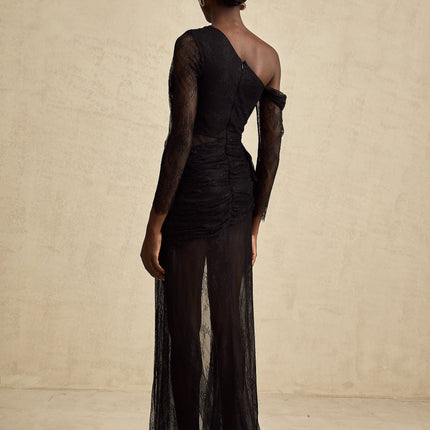 A black floorlength maxi dress with a single shoulder strap and a cut out detail