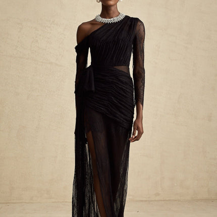 A black floorlength maxi dress with a single shoulder strap and a cutout detail on one side
