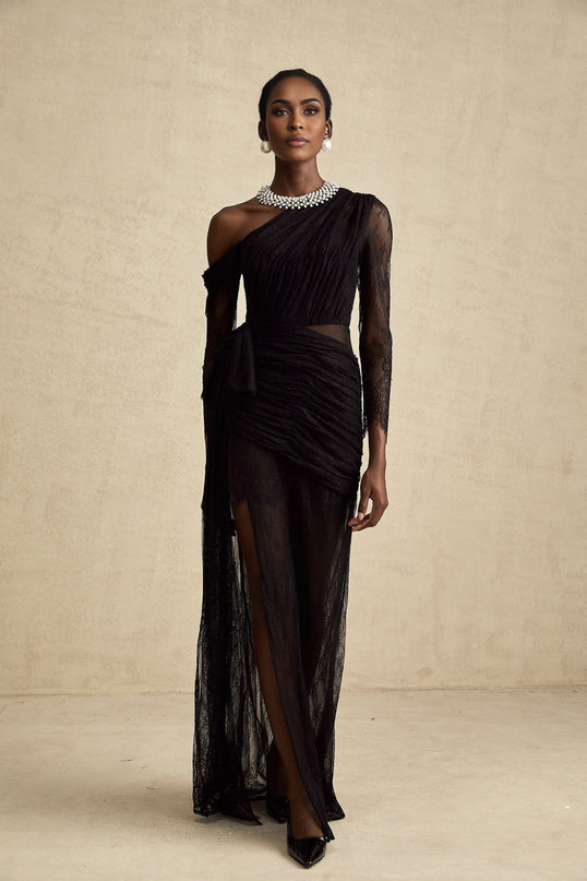 A black floorlength maxi dress with a single shoulder strap and a cutout detail on one side