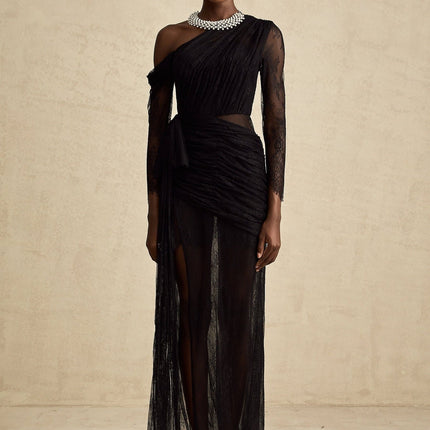 A black floorlength maxi dress with a single shoulder strap and a cutout detail on one side