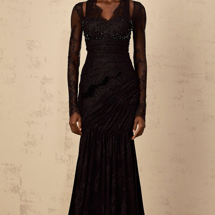 A black floorlength mermaid style dress with floral lace detailing named Ursula