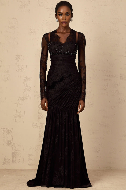 A black floorlength mermaid style dress with floral lace detailing named Ursula