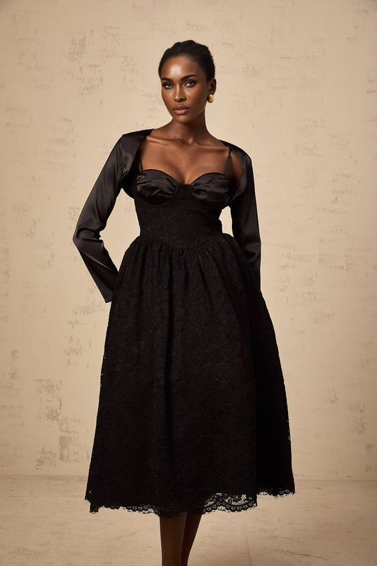 A black floral lace matching set consisting of a top and dress featuring delicate lace patterns and a feminine silhouette