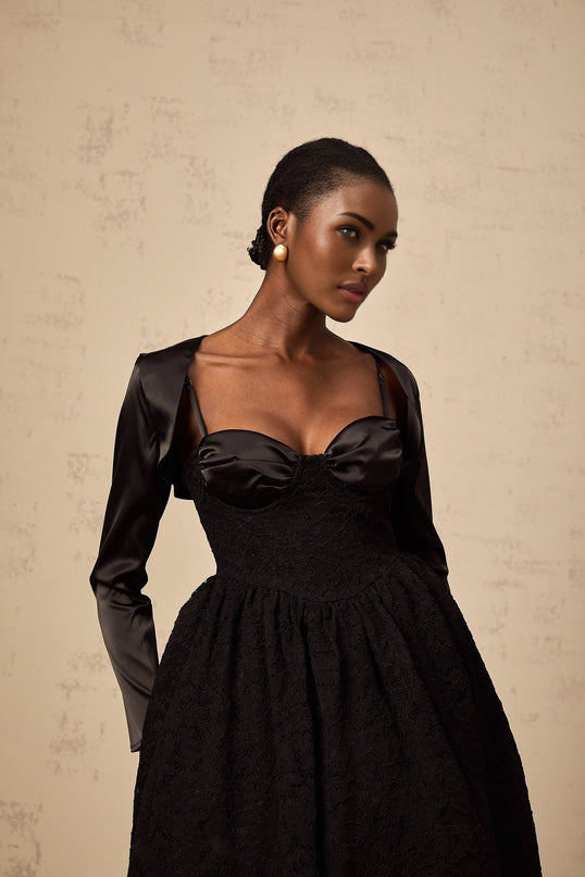 A black floral lace matching set including a top and dress with delicate lace pattern details