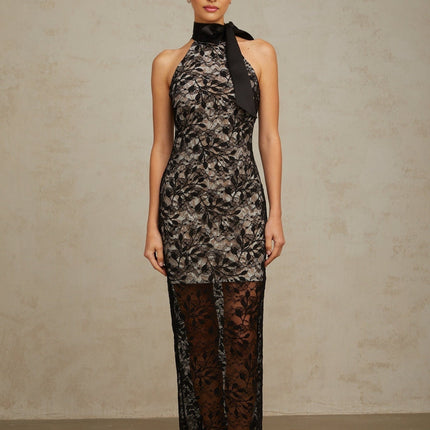 A black floral lace maxi dress with a halter neckline named Coralie featuring a long flowing skirt and delicate lace pattern throughout
