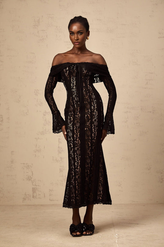 A black floral lace midi dress with flared cuffs named Emeline featuring an intricate floral pattern throughout the fabric and a fitted silhouette that flares out slightly at the bottom